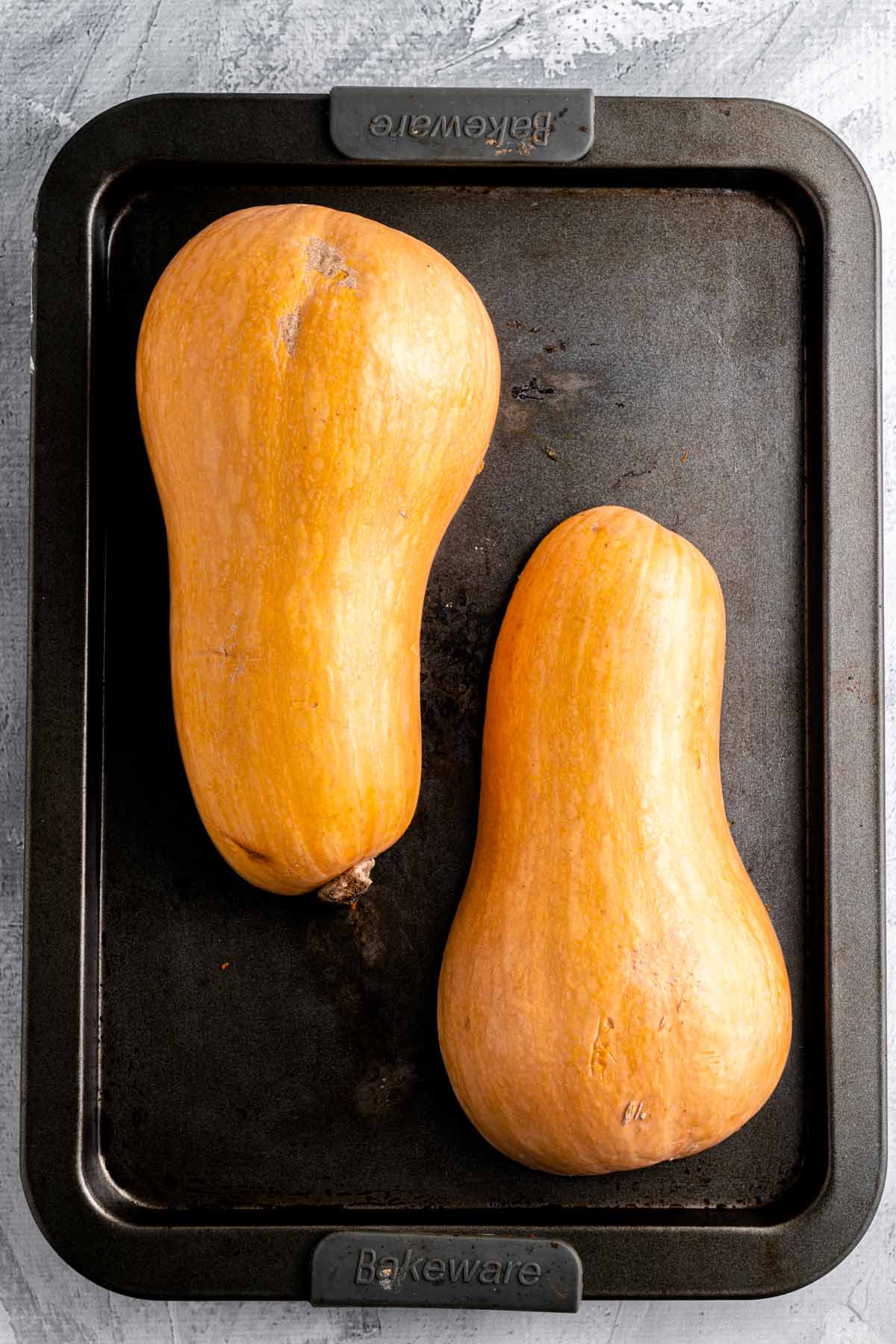 skin side down butternut squash halves on baking sheet.