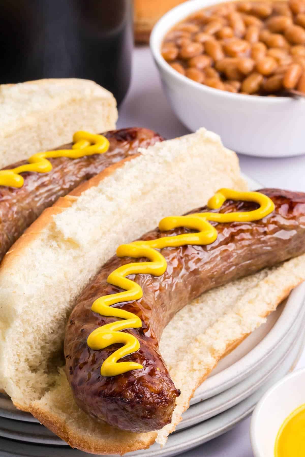 brats in buns with mustard.