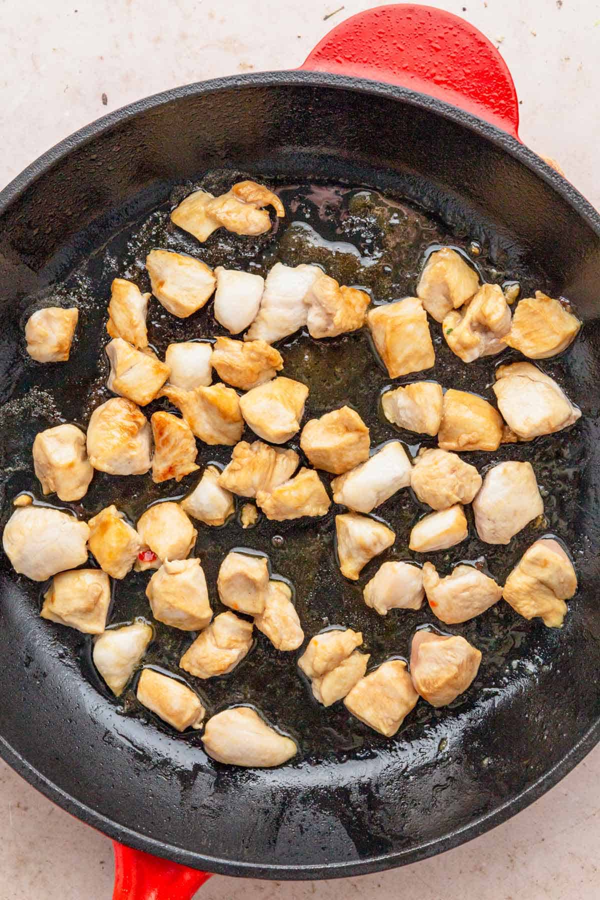 cooking chicken in skillet.