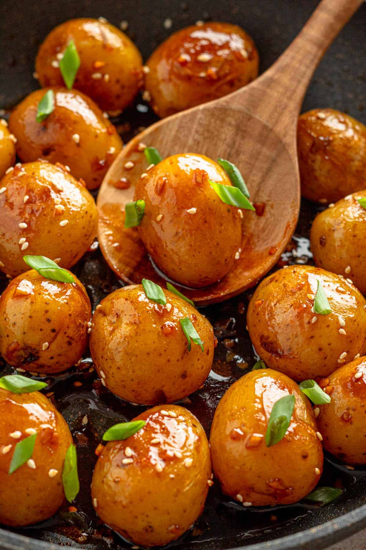 baby potatoes in dark sauce and sesame seeds.