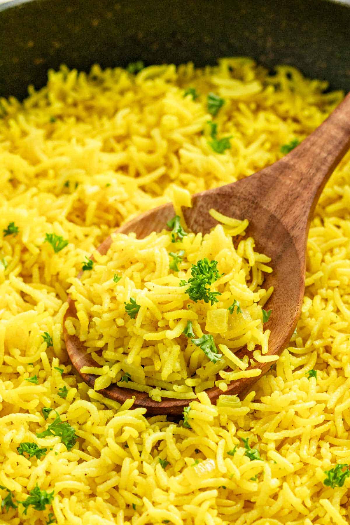 a skillet with yellow turmeric rice.