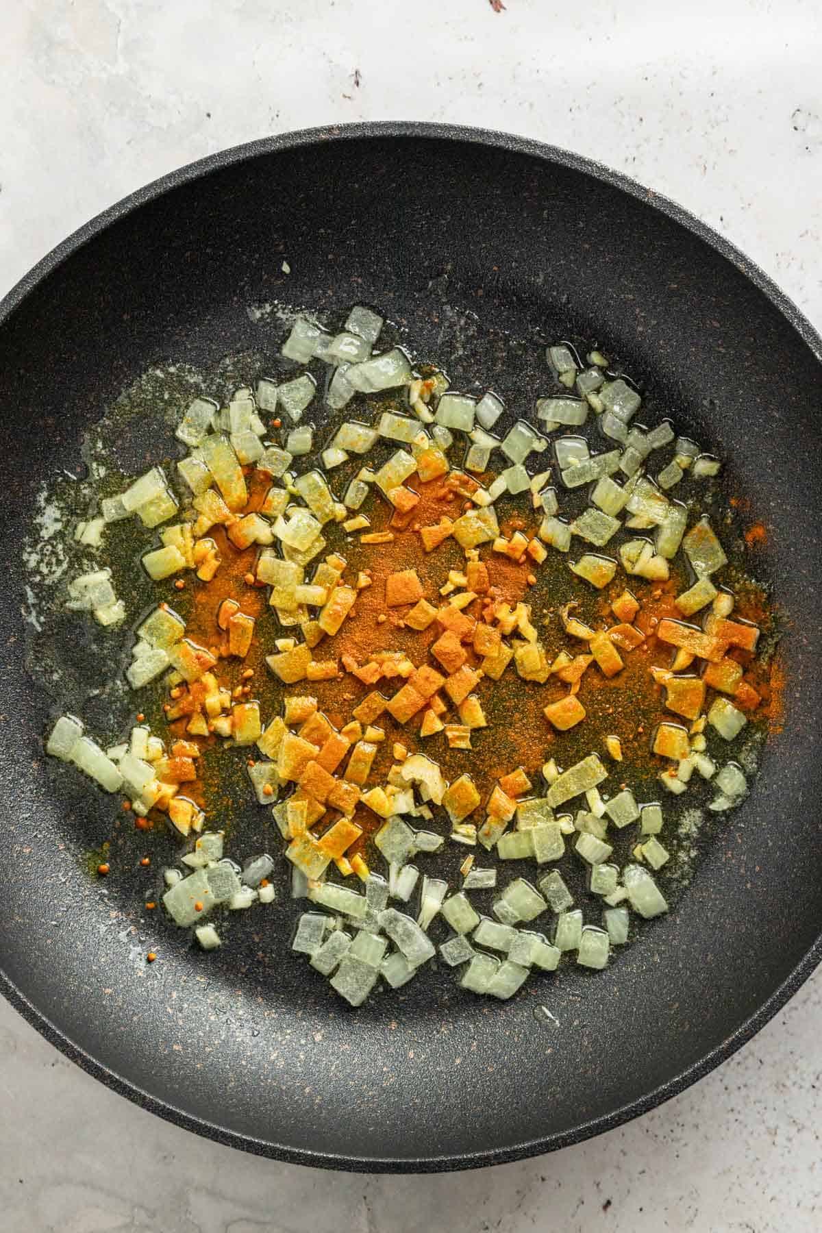 turmeric and chopped onion in skillet.