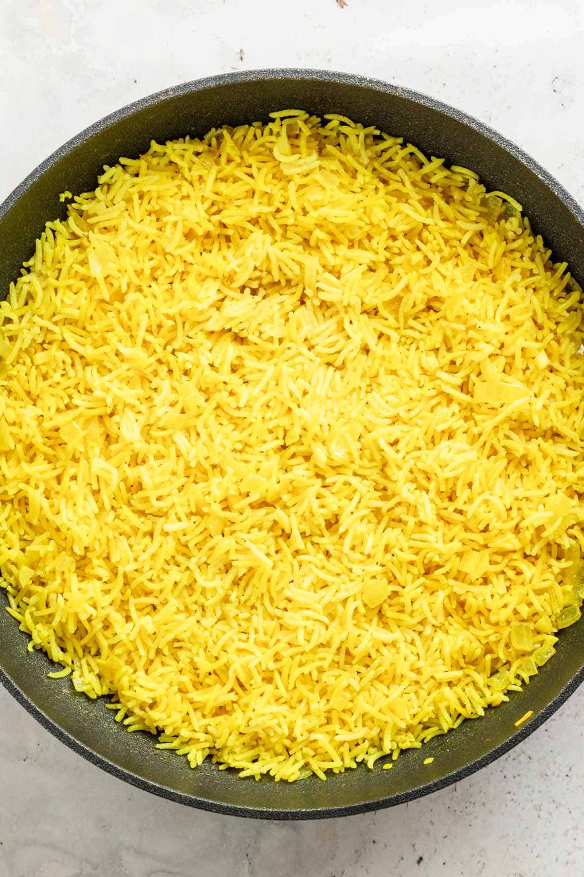 cooked yellow rice in skillet.