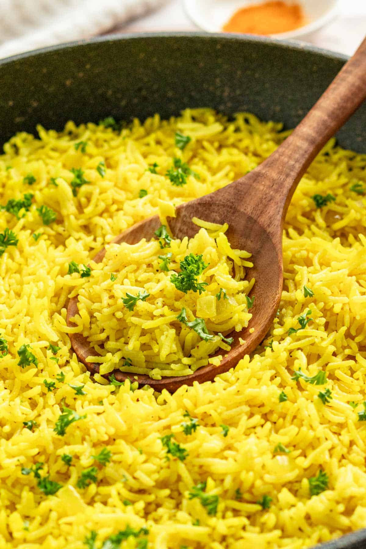 yellow rice in skillet with parsley.