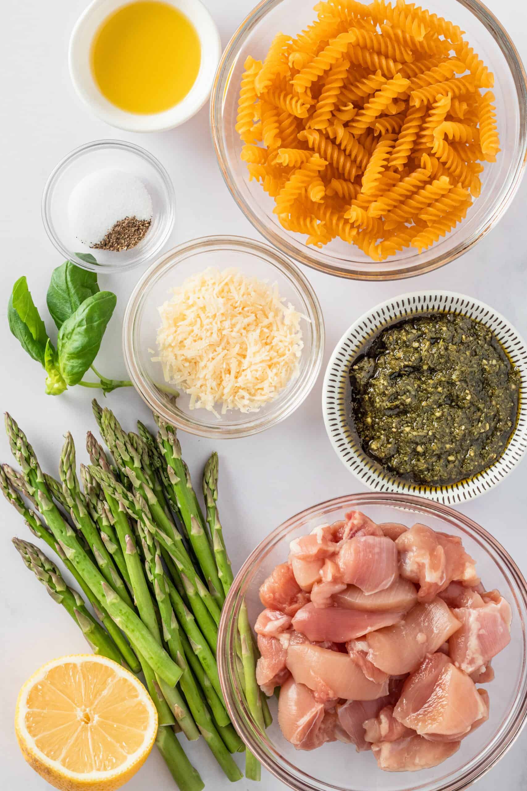 Ingredients for asparagus pasta: chicken, pesto, pasta, asparagus, lemon, cheese