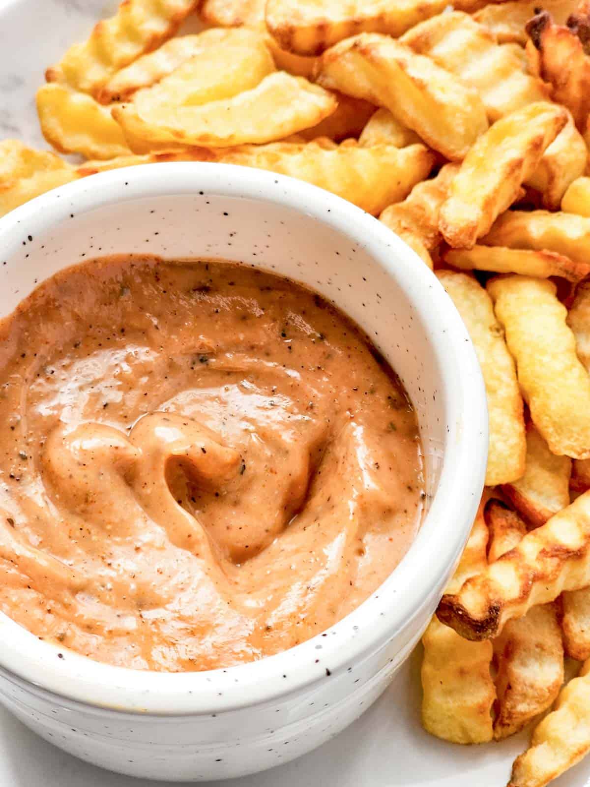 raising cane's sauce with fries.