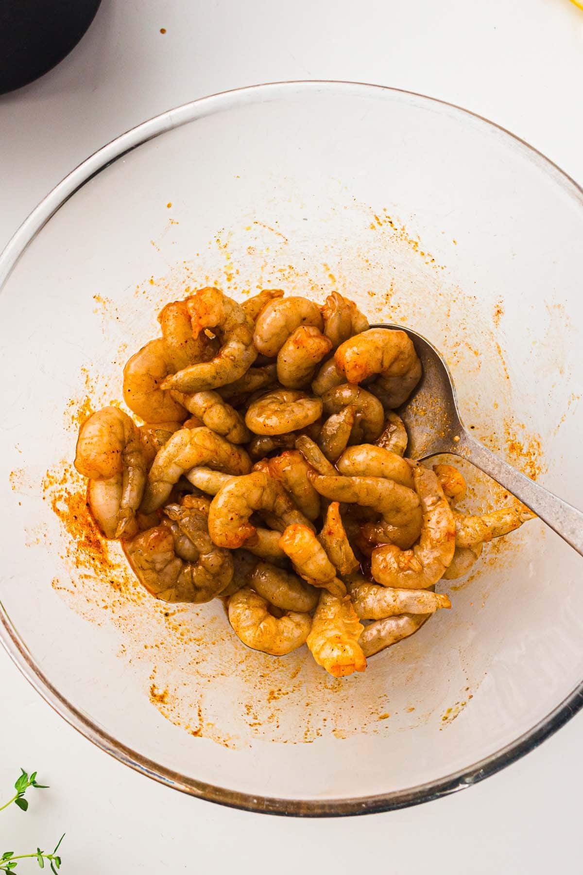 seasoned raw shrimp in a bowl.