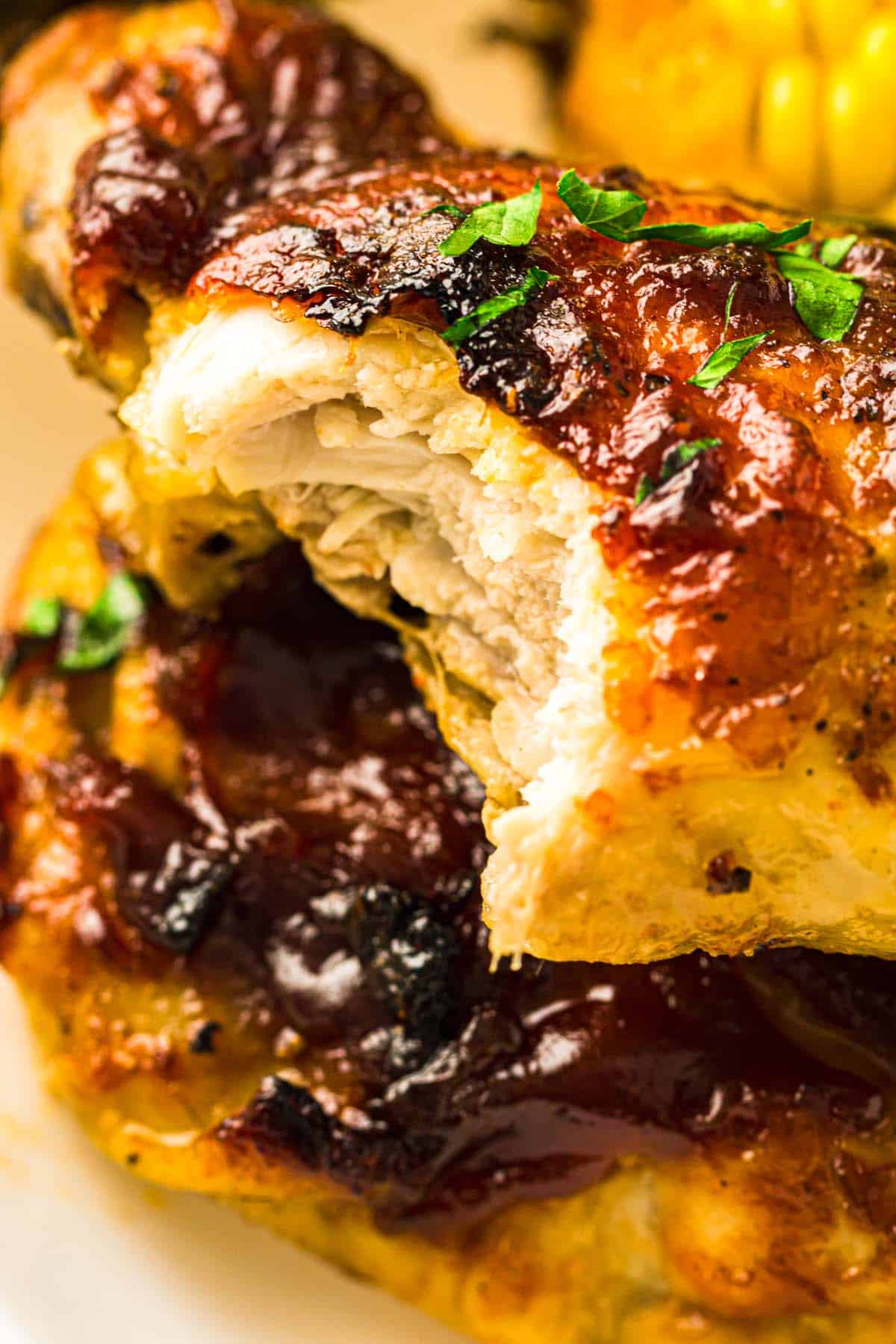 A plate topped with chicken and corn.