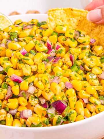 Mexican fresh corn salsa served with tortilla chips for dipping.