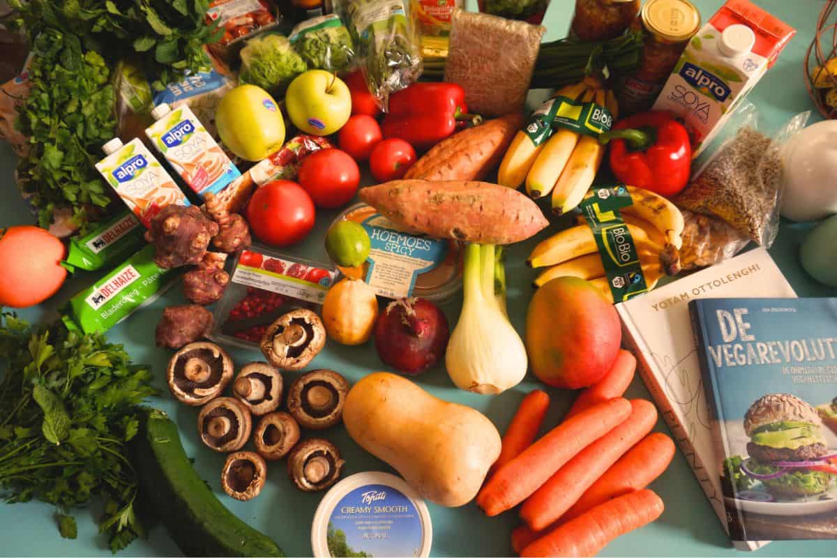 Fresh fruits and vegetables spread out on a table for meal prep