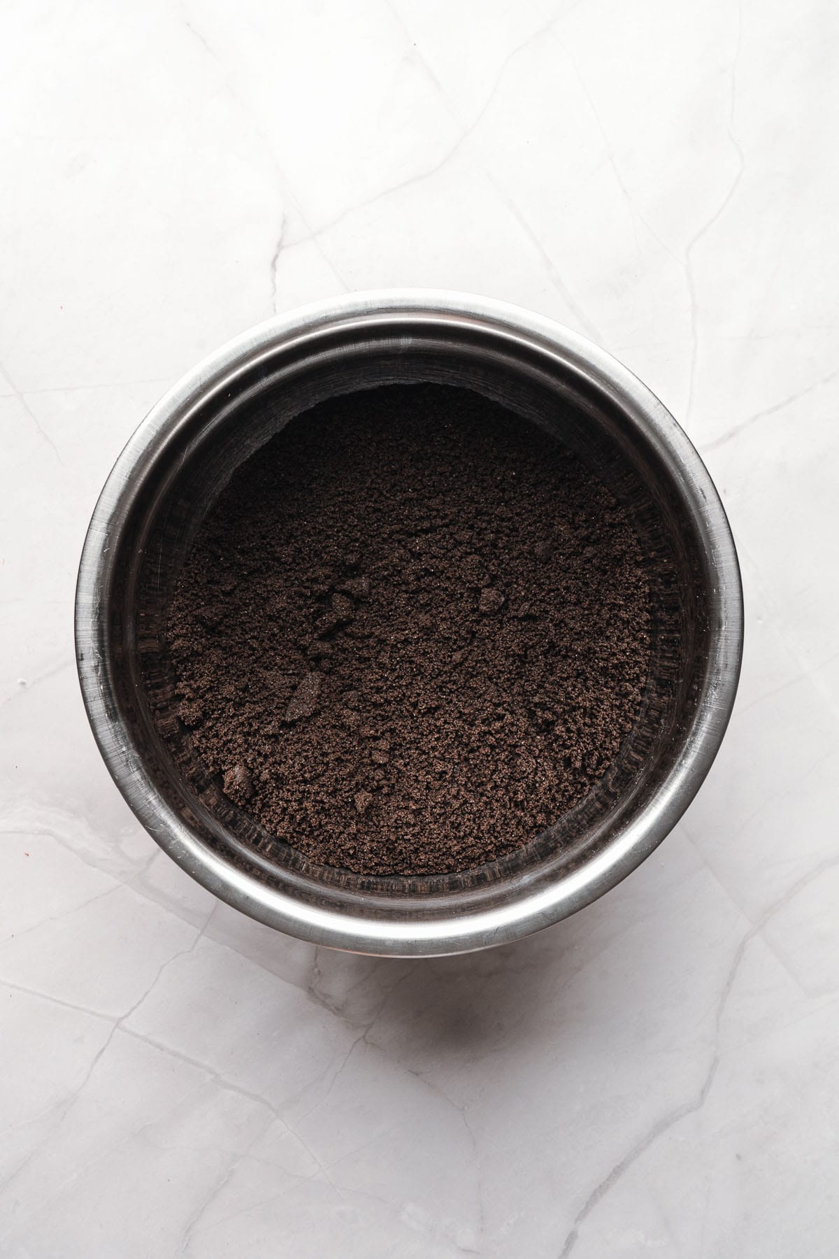 Finely ground Oreo crumbs in a mixing bowl.