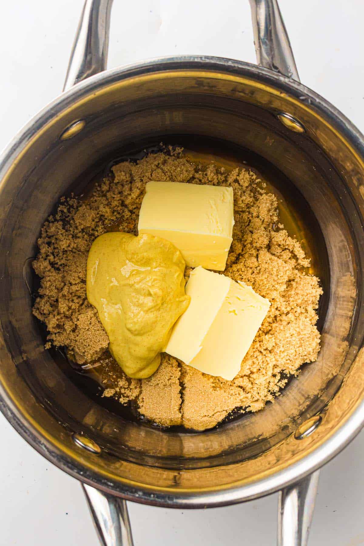 Mustard added to butter and sugar mixture.
