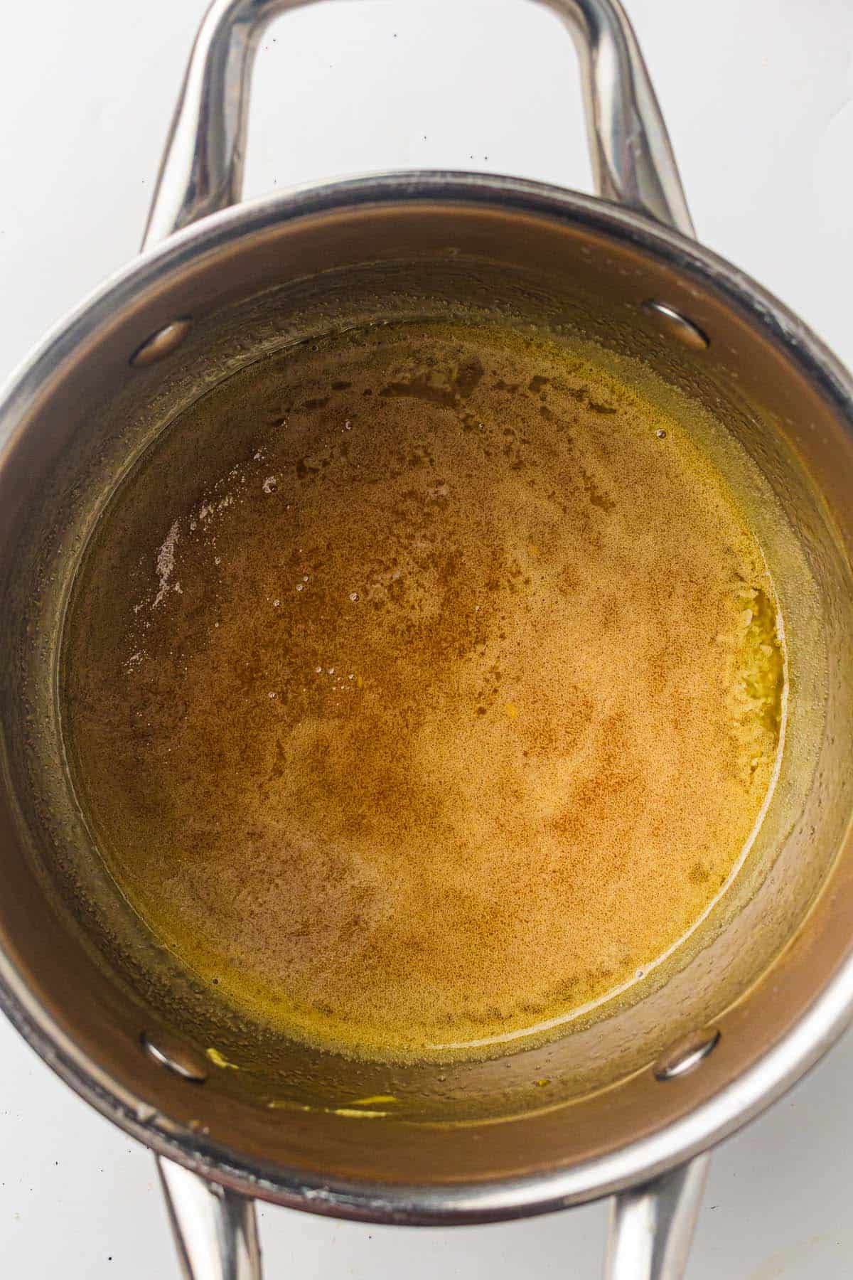 Honey glaze bubbling in a saucepan.