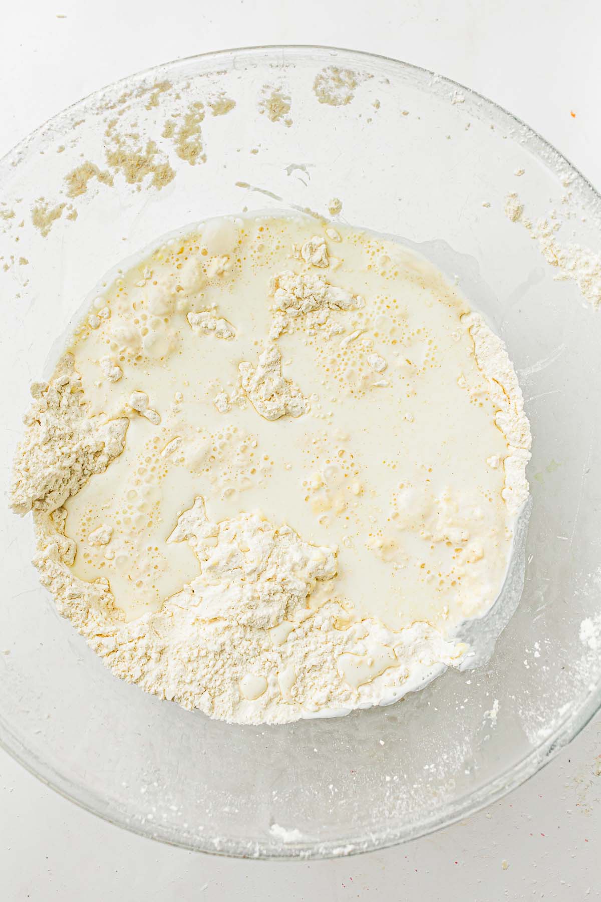 Milk poured into flour and butter mixture in a bowl.