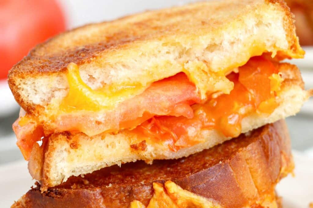 Melted grilled cheese sandwich with tomato filling