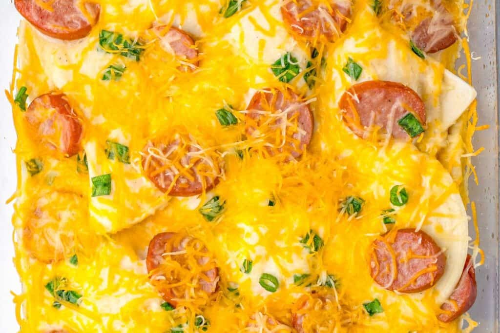 Baked casserole with sausage slices and melted cheese