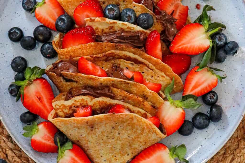 Folded crepes with strawberries and chocolate spread
