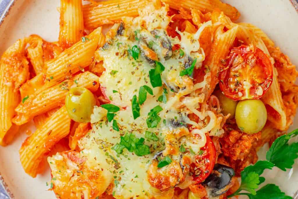 Baked pasta with creamy tomato sauce and herbs