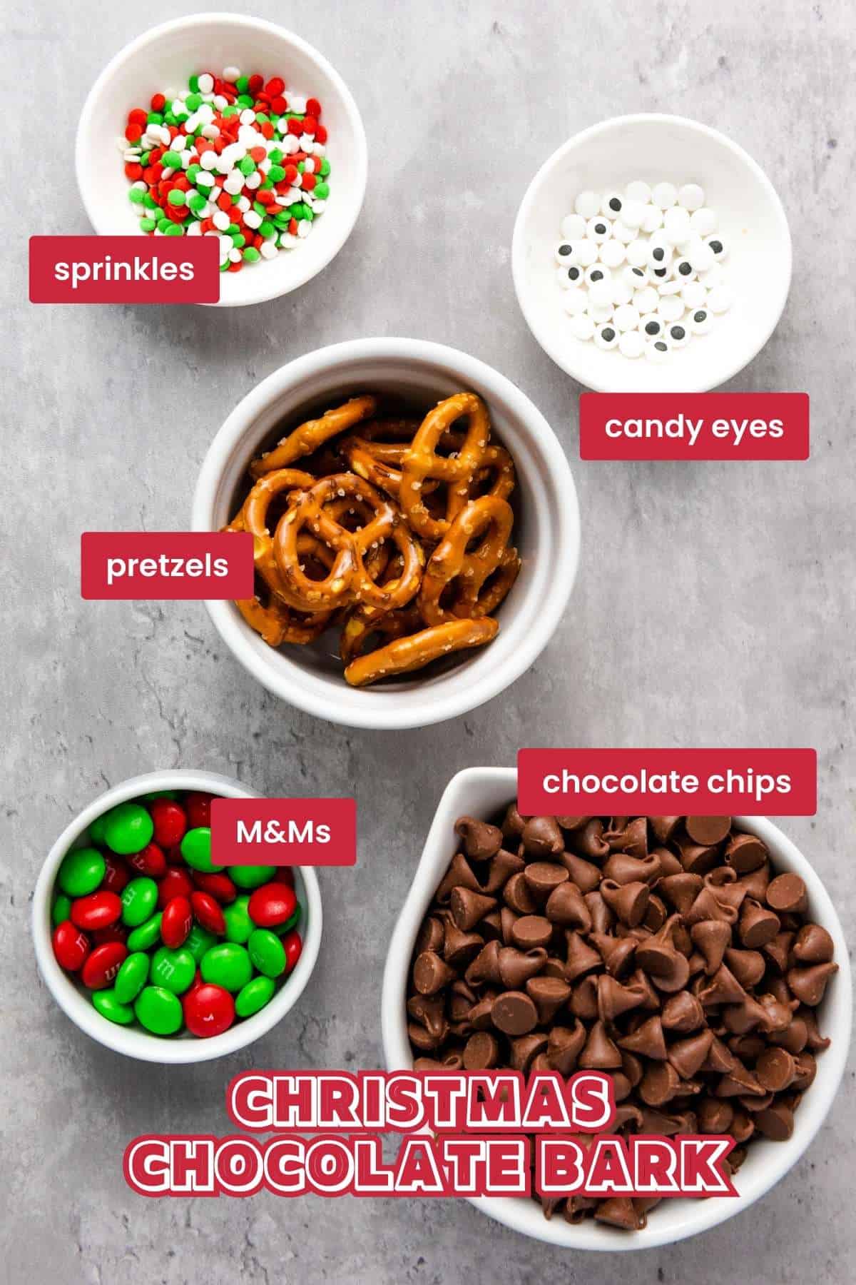Ingredients for Christmas chocolate bark: chocolate chips, pretzels, M&Ms, sprinkles, candy eyes.