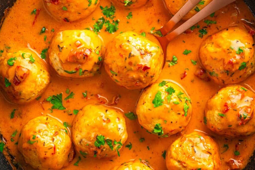Chicken meatballs in creamy tomato sauce with herbs