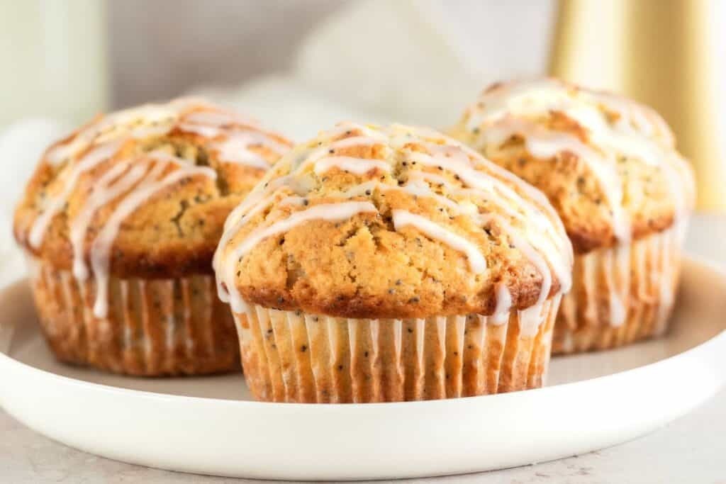 Lemon poppy seed muffins with glaze on a plate