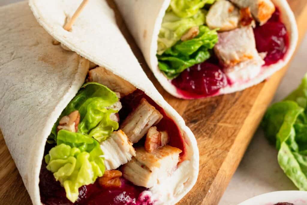 Turkey avocado wrap with lettuce and tomato in a tortilla