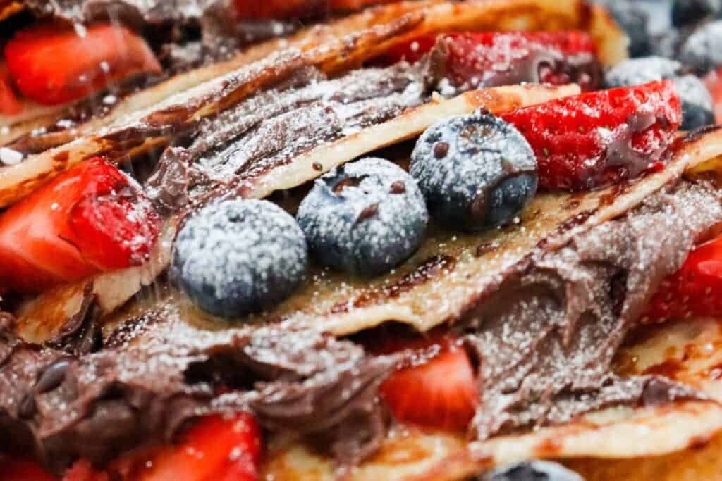 Nutella crepes topped with strawberries and blueberries