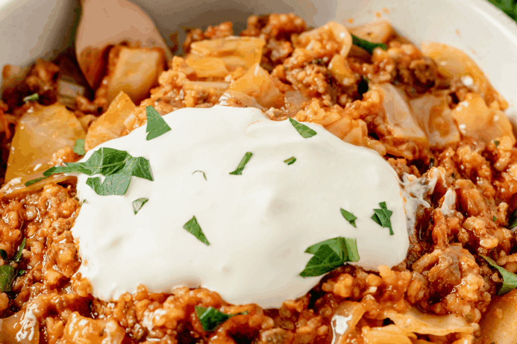 Ukrainian lazy cabbage rolls topped with sour cream