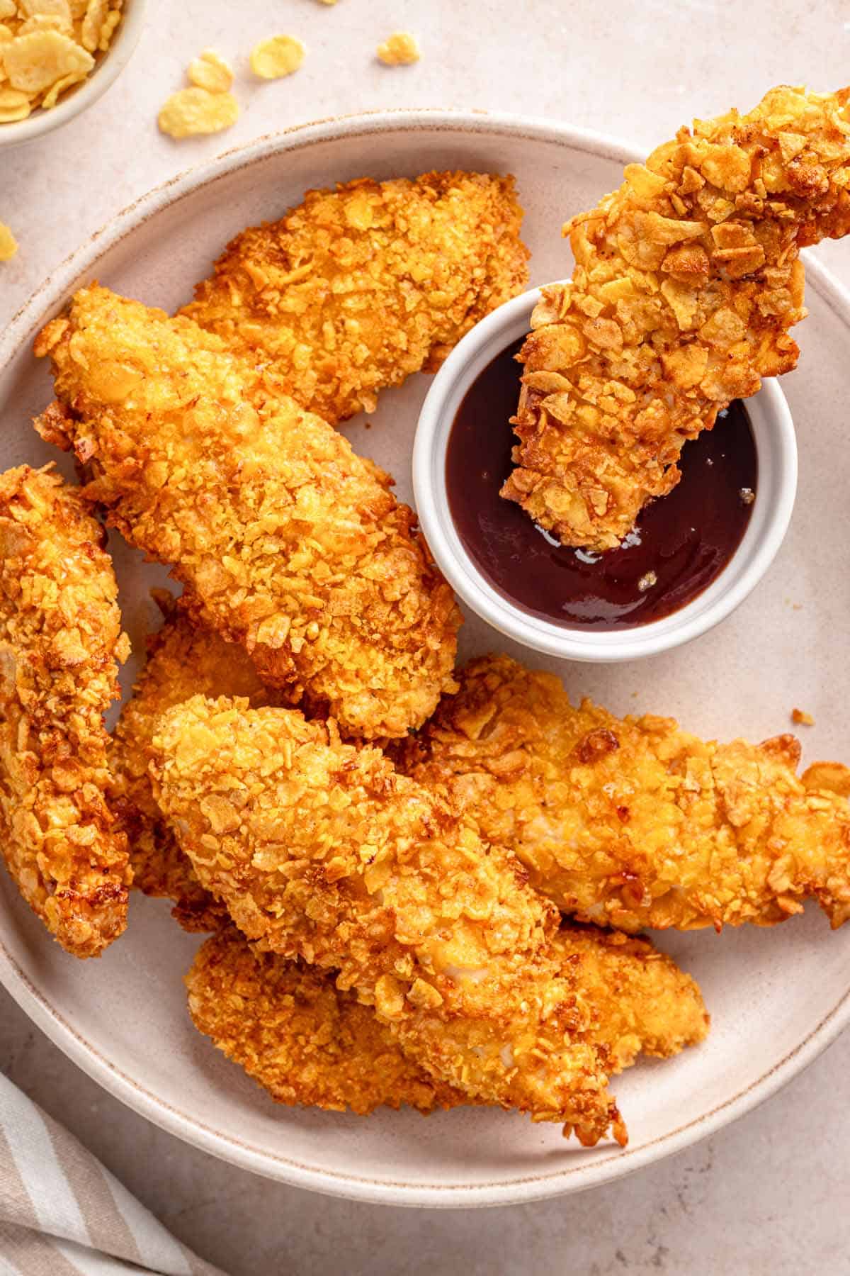 Crispy cornflake chicken tenders served with barbecue dipping sauce