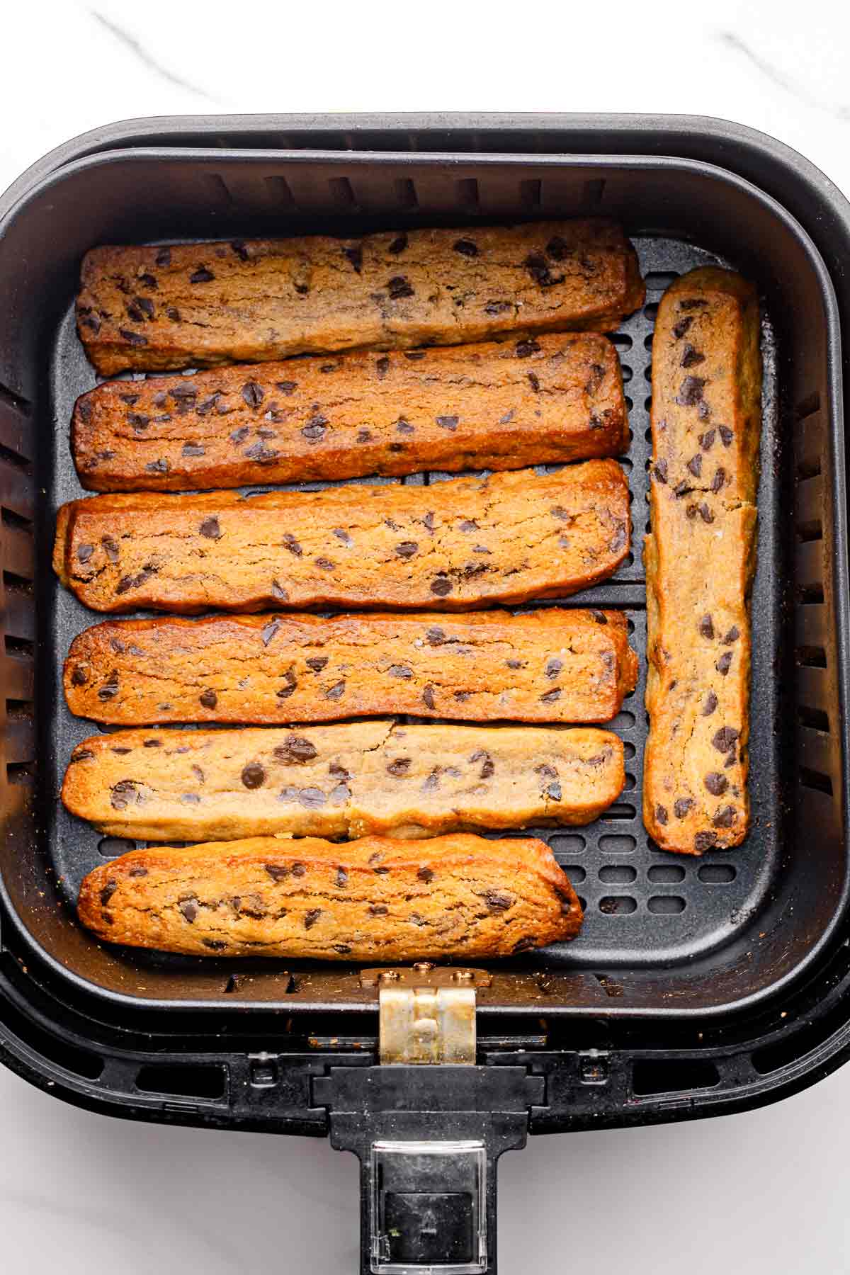 Golden brown cookie fries cooked in an air fryer basket