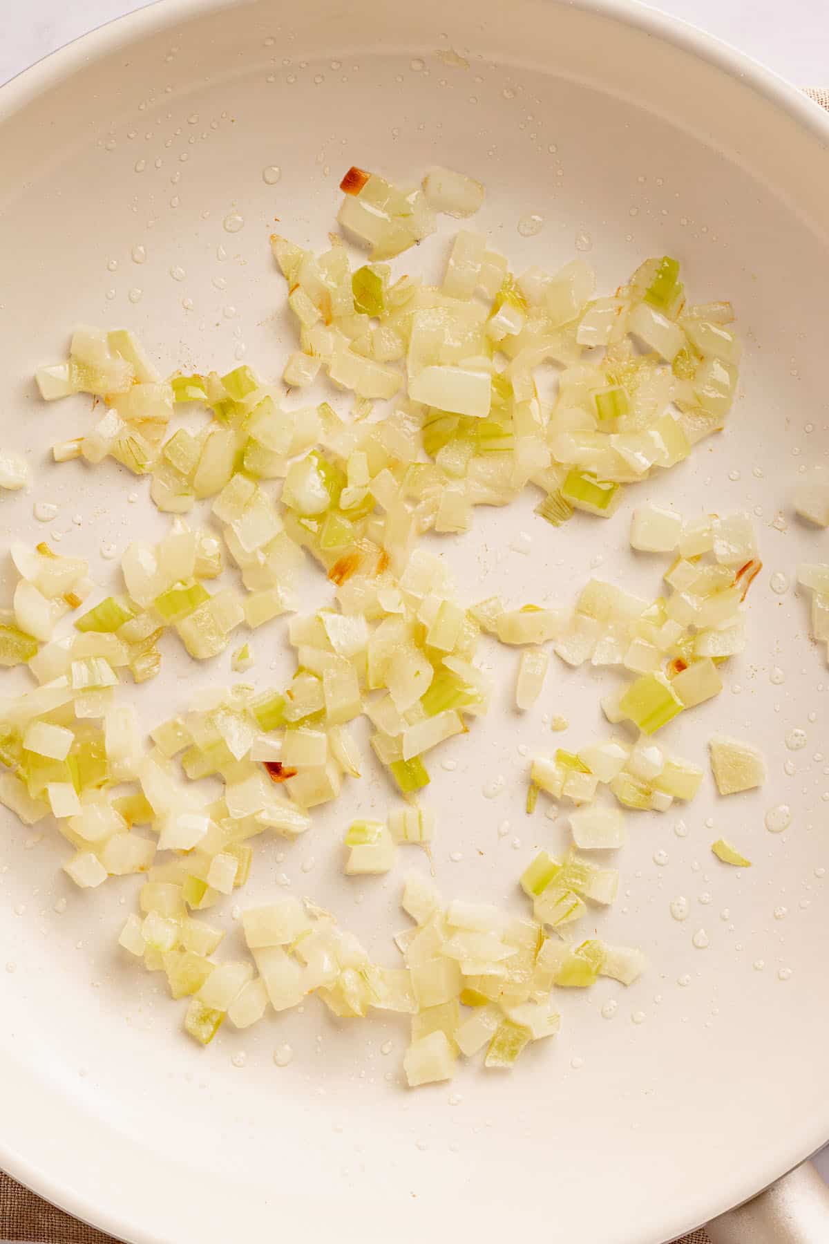 Chopped onion sautéing in a skillet