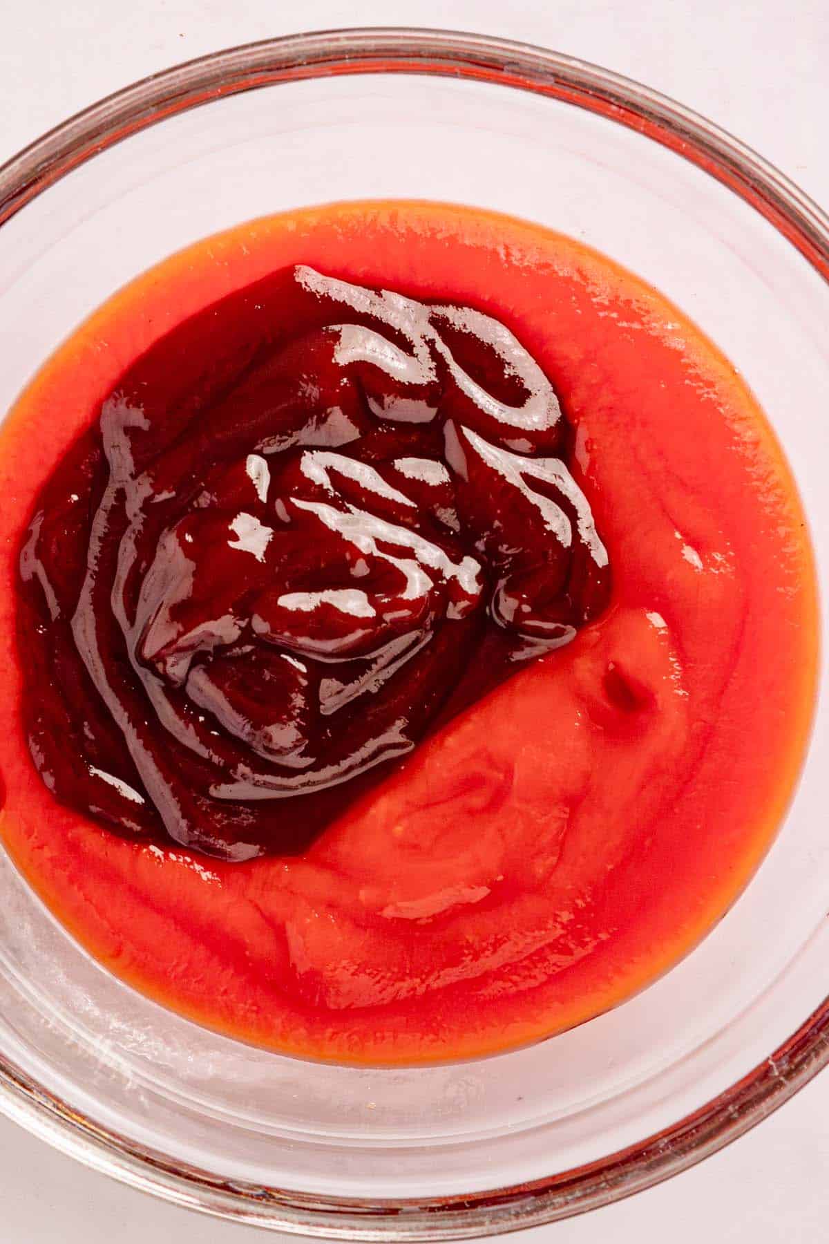 Ketchup and BBQ sauce in a small glass bowl