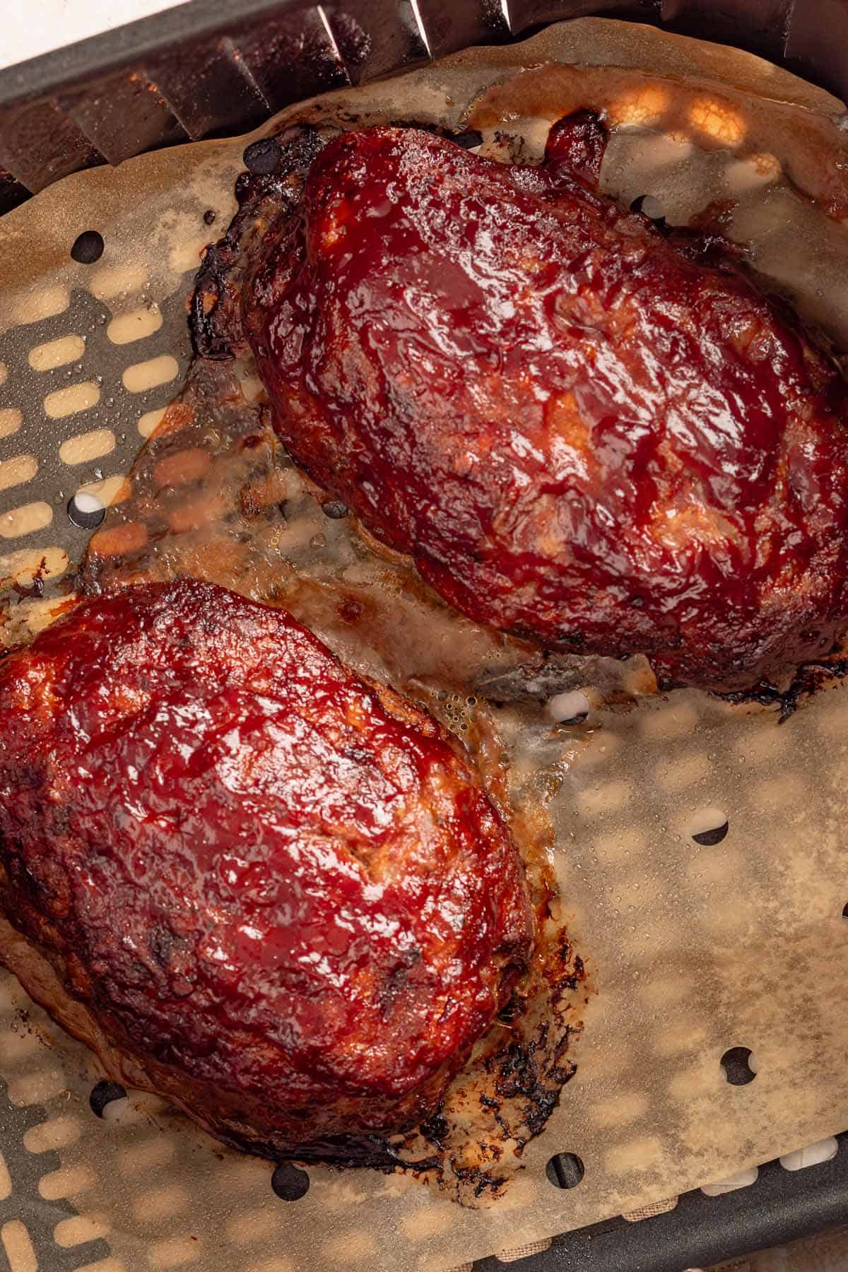 Glazed air fryer meatloaves in an air fryer basket