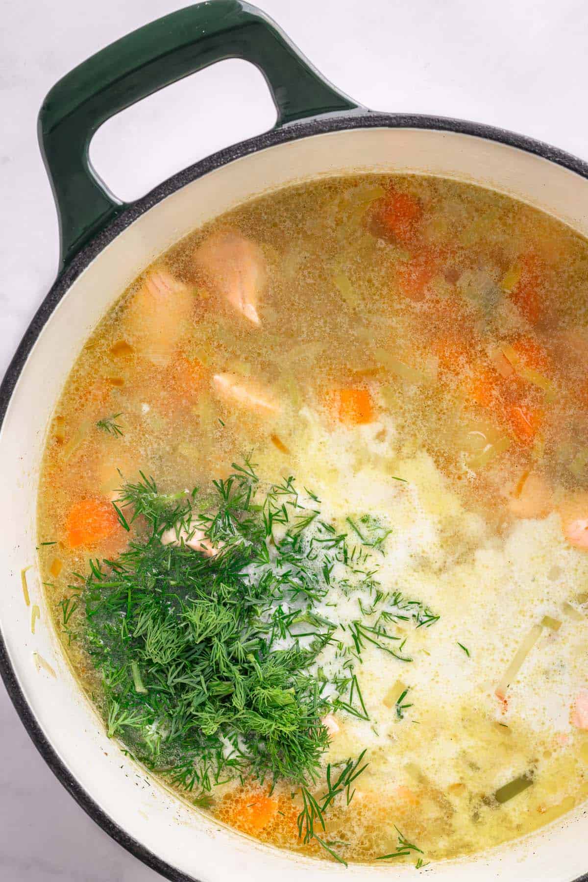 Fresh dill and cream added to Finnish salmon soup.