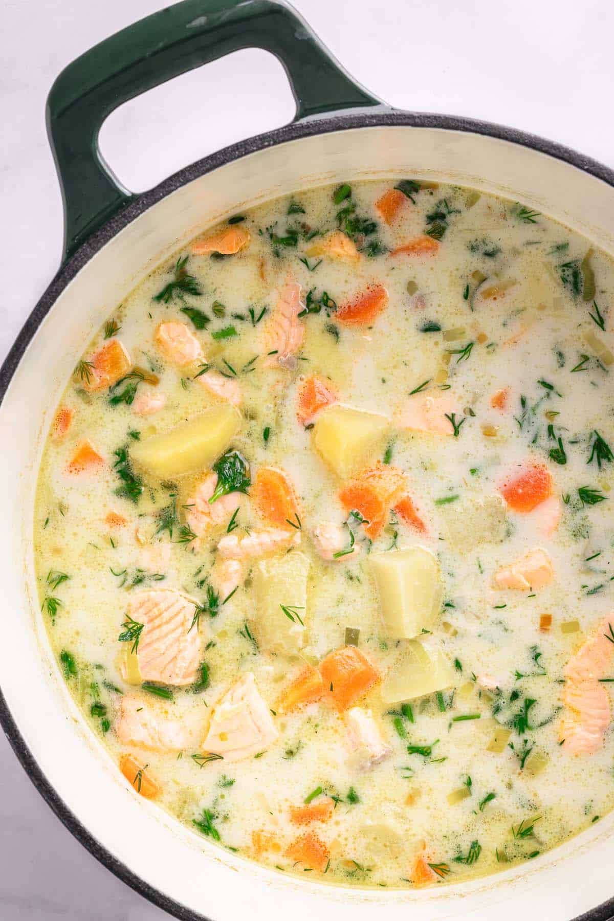Creamy Finnish salmon soup finished and ready to serve in the pot.
