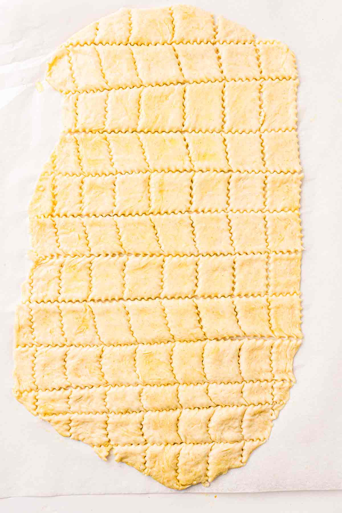 Herb-seasoned cracker dough cut into squares