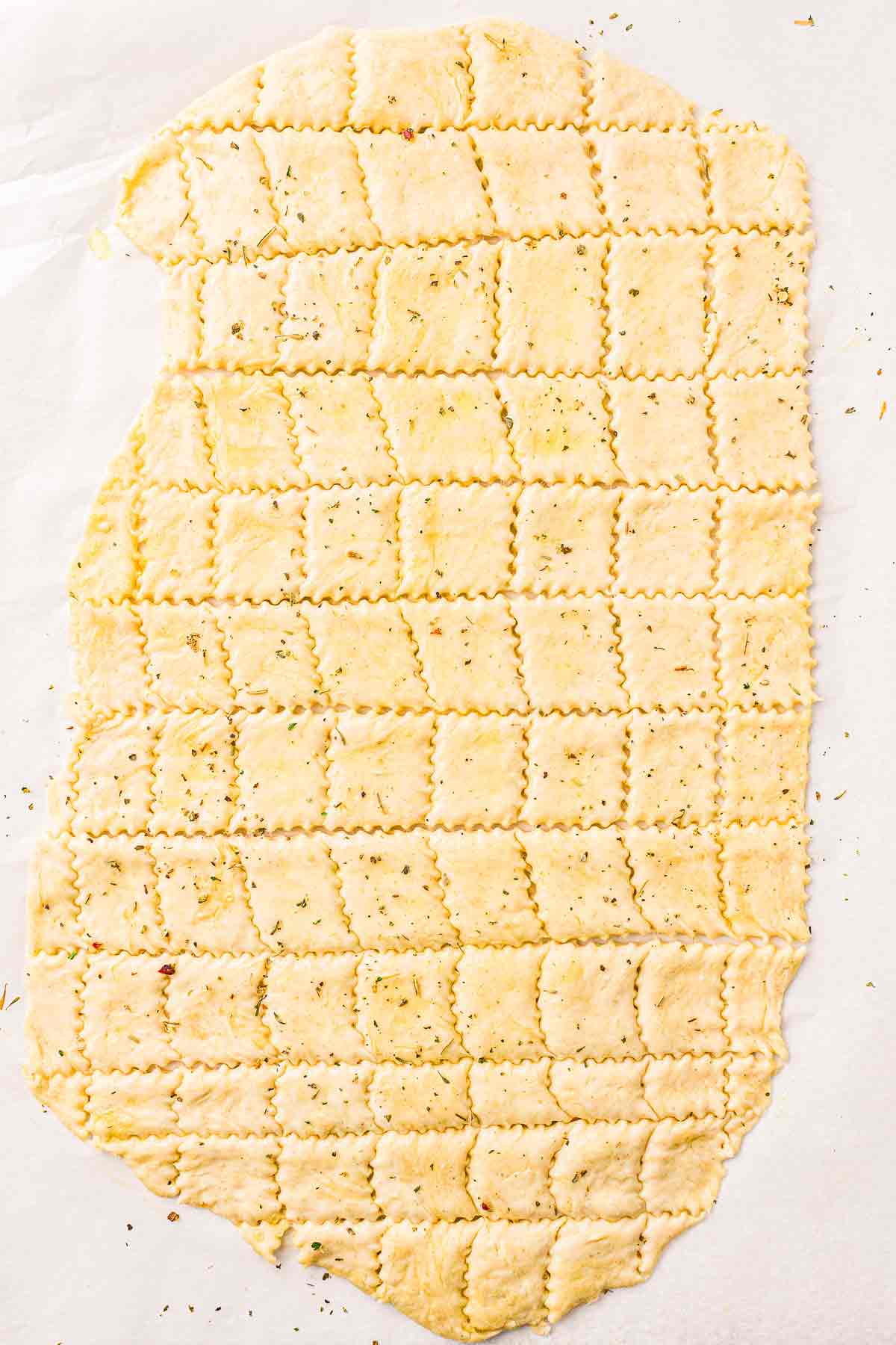 Baked sourdough crackers on a parchment-lined baking sheet