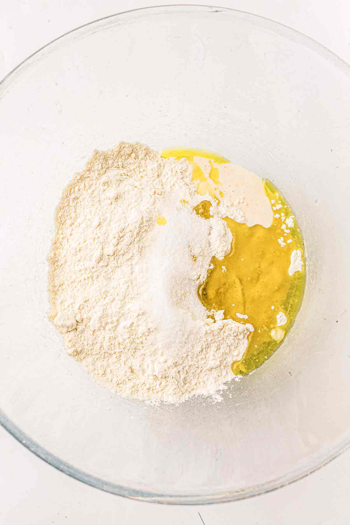 Flour, olive oil, salt, and sourdough discard in a mixing bowl