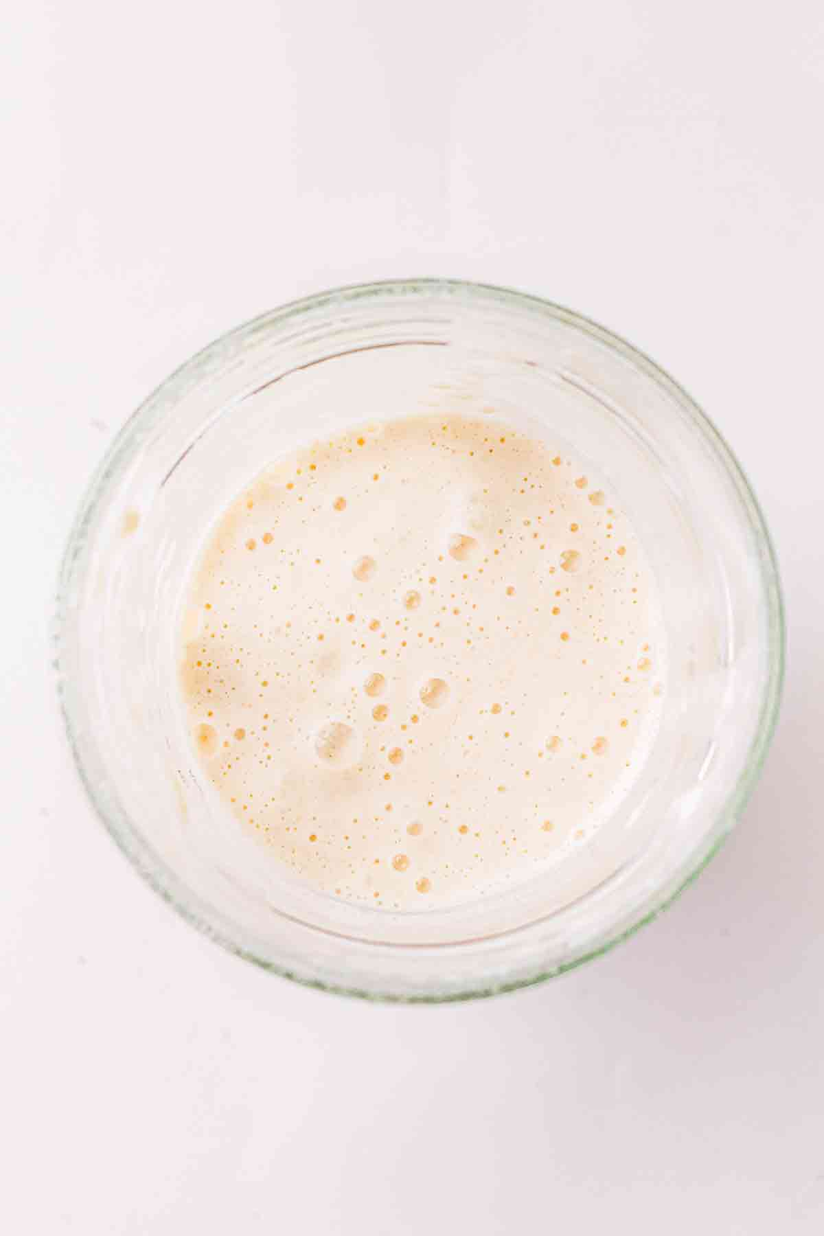 Top view of bubbly sourdough discard in a glass jar