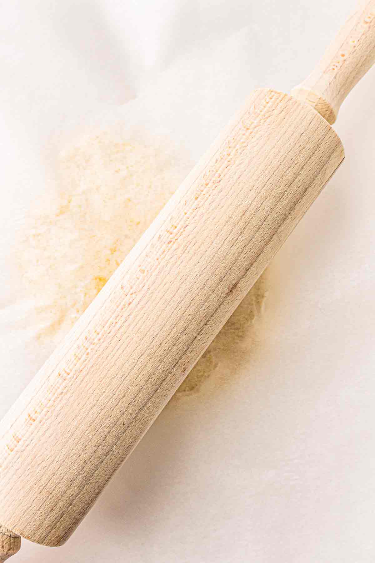 Rolling pin flattening sourdough cracker dough