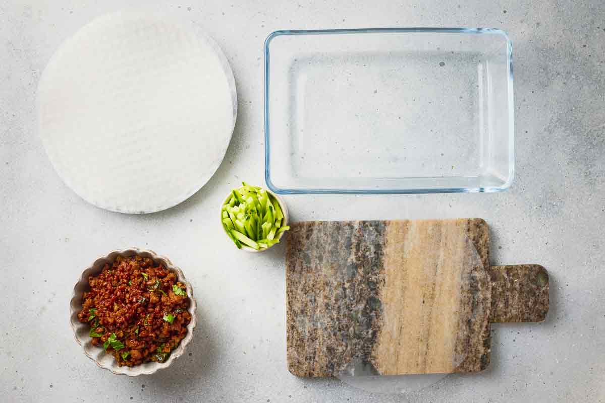 Rice paper wrapper softened in warm water before assembling spring rolls.