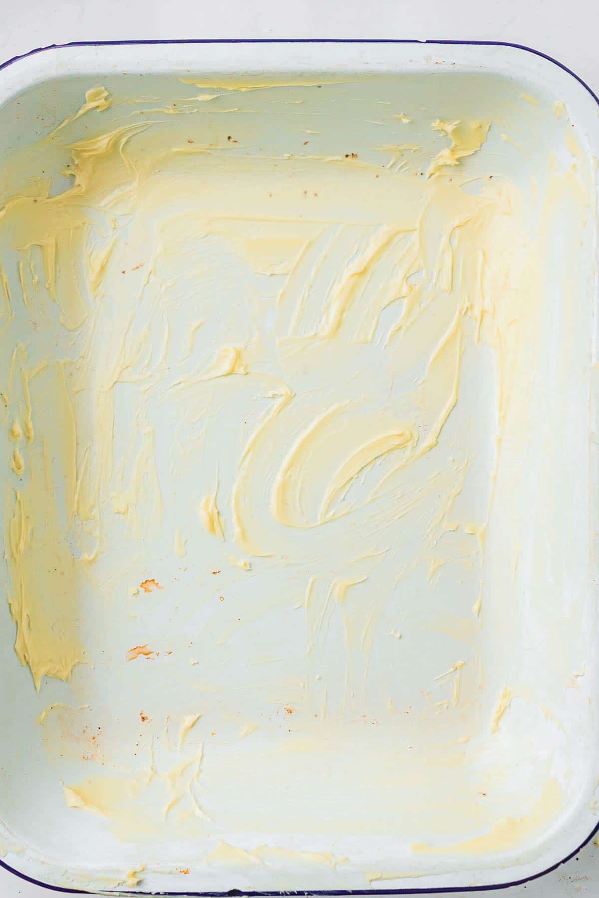 Buttered baking dish prepared for shaping the dinner rolls.