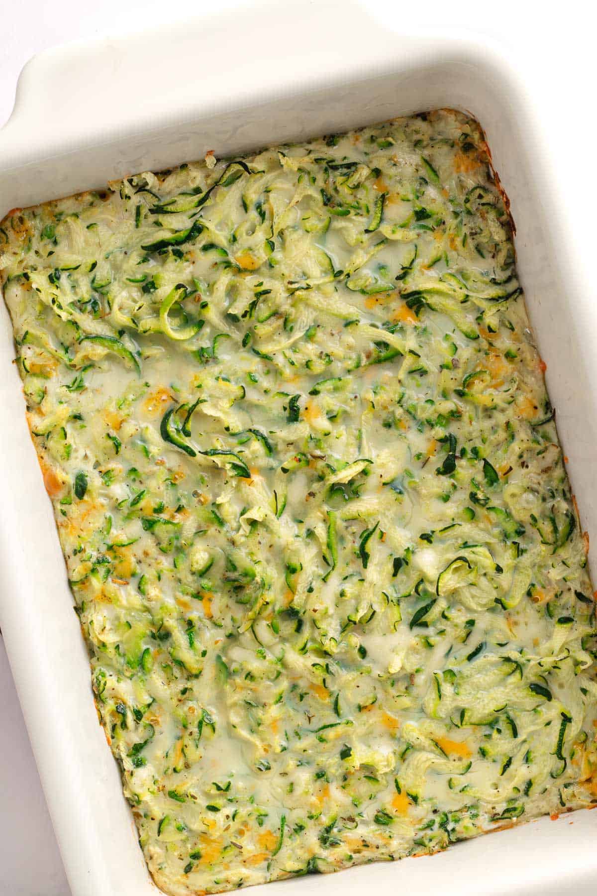 Partially baked zucchini casserole before adding the breadcrumb topping
