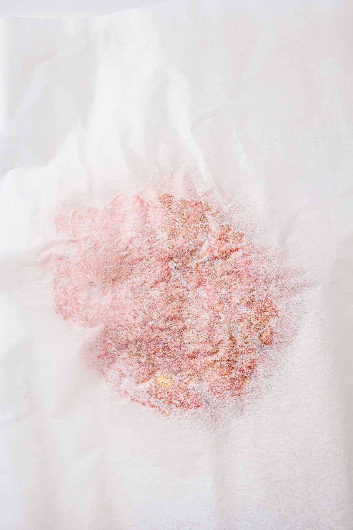 Ground meat covered with parchment paper before rolling into a rectangle