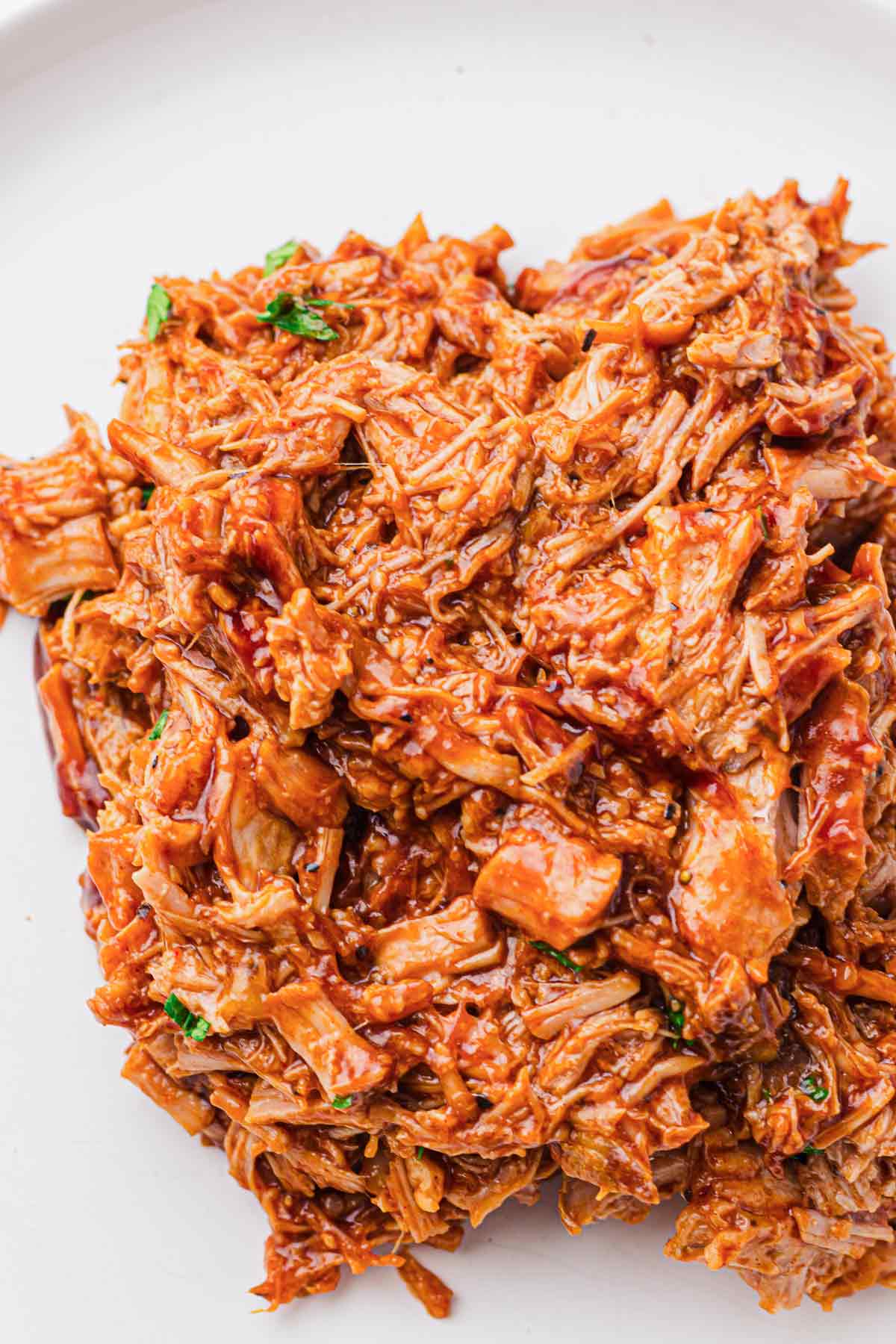 Close-up of shredded BBQ pulled pork coated in barbecue sauce
