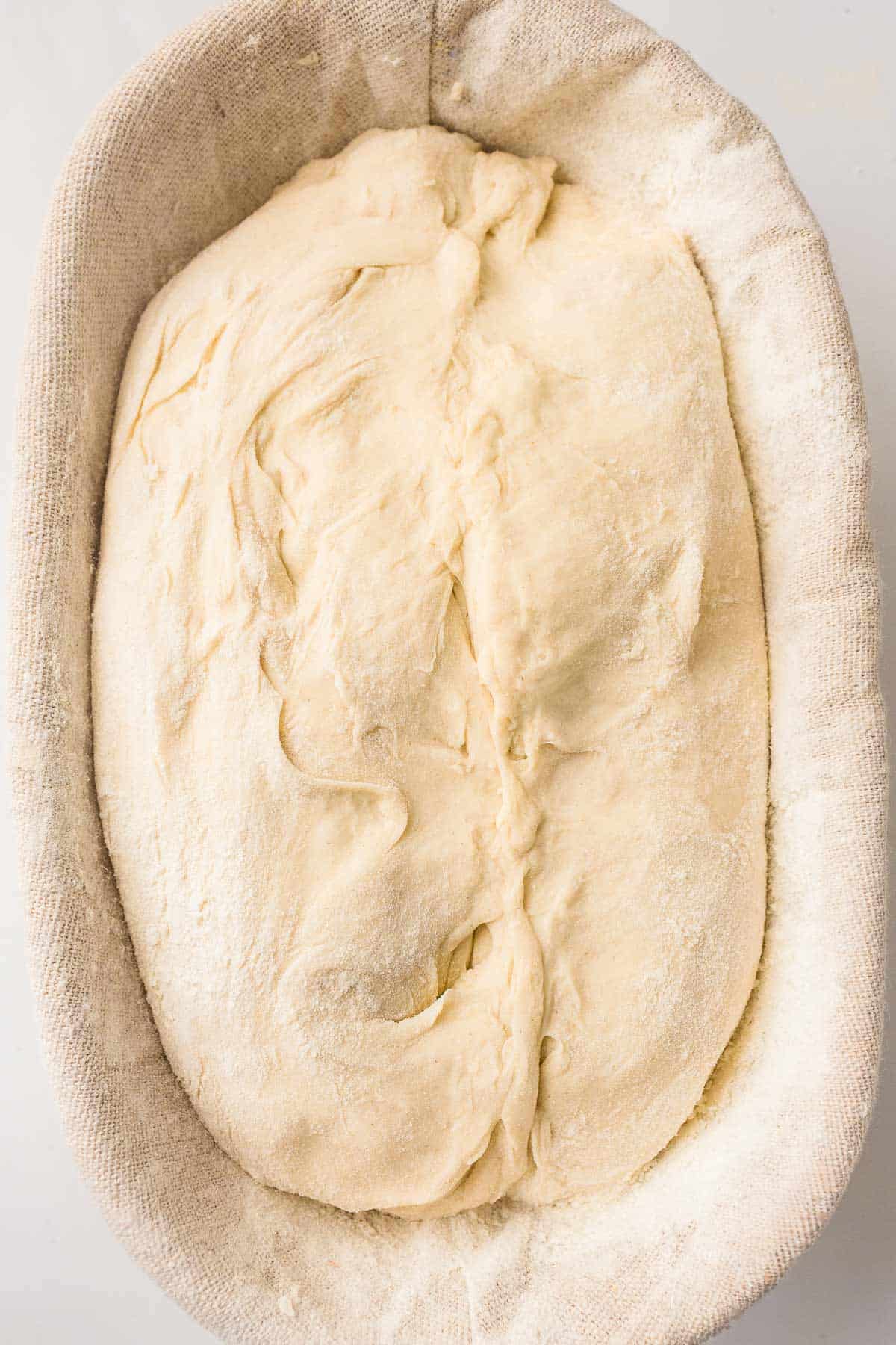Sourdough dough after shaping in a proofing basket