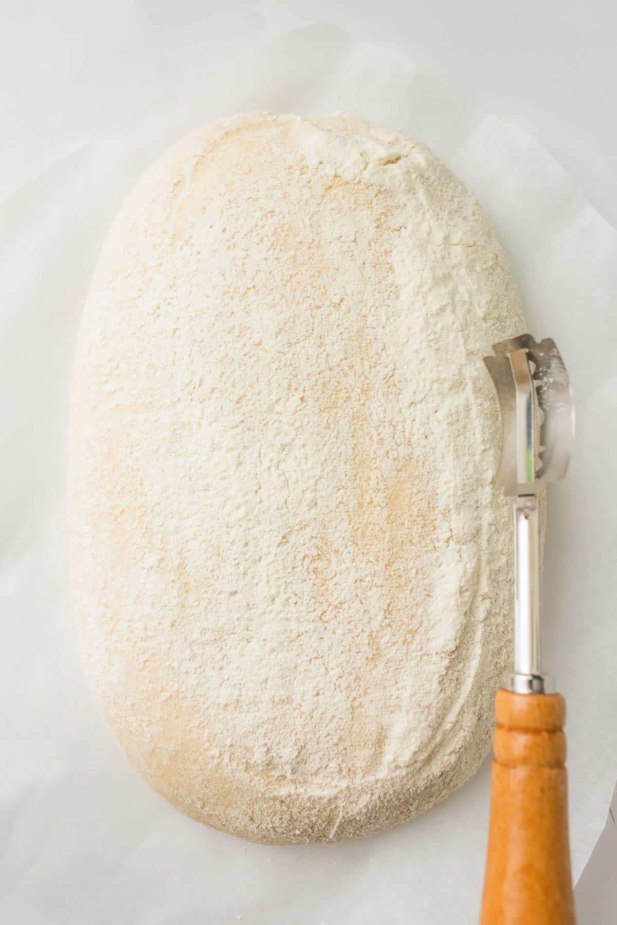 Proofed sourdough dough dusted with flour before baking