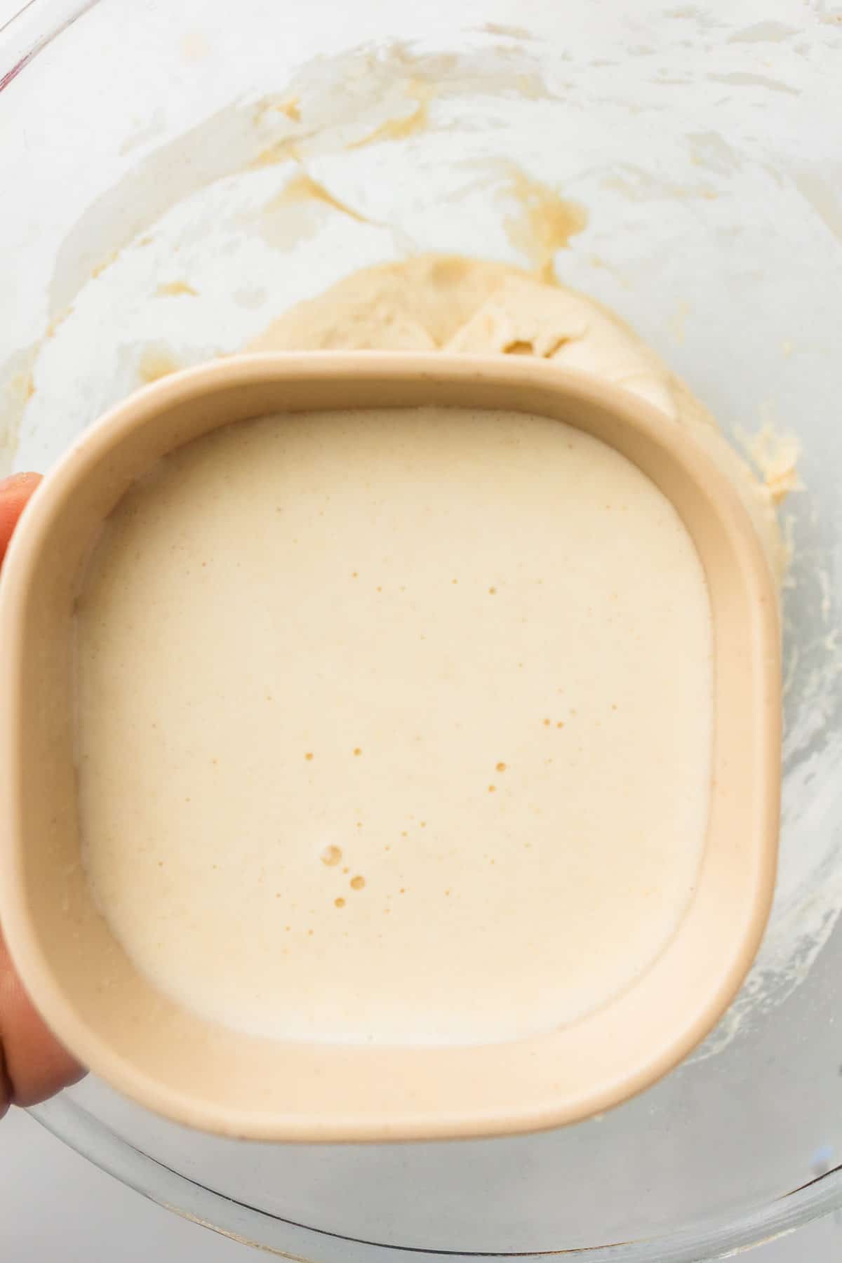 Water poured into a bowl for mixing sourdough dough