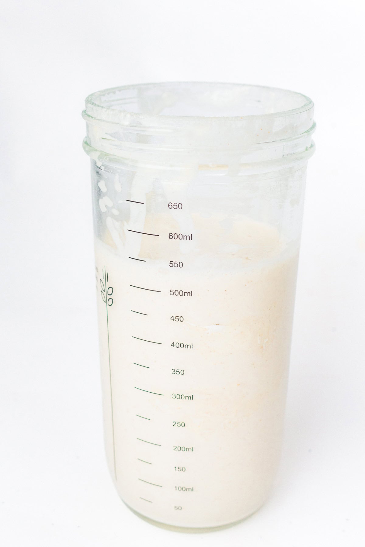 Fed sourdough starter in a clear measuring container before baking